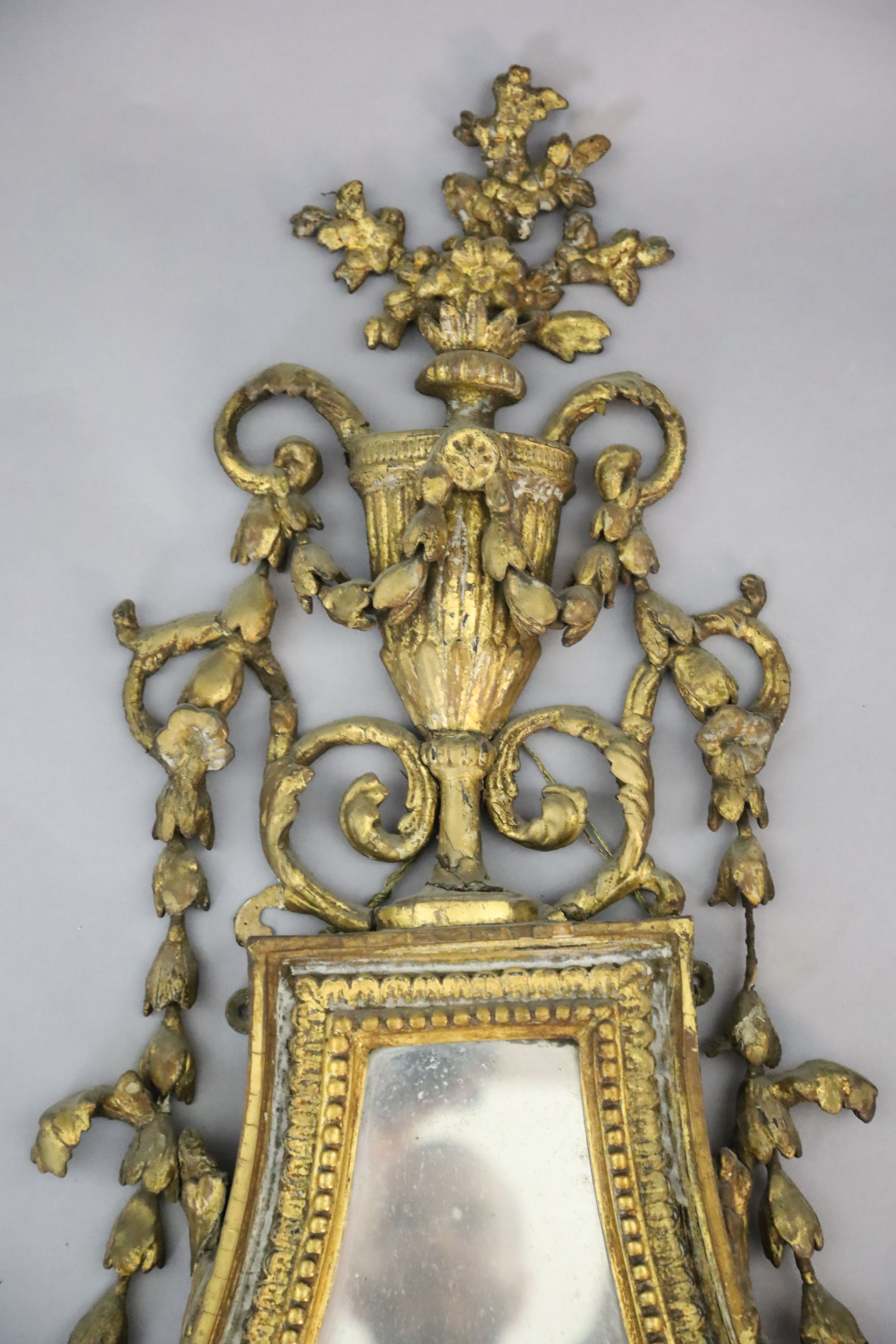 An early 19th century giltwood and gesso wall mirror, W.1ft 10in. H.3ft 9in.